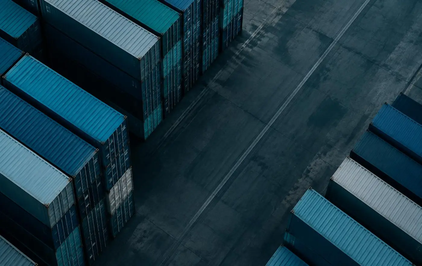 Shipping containers in ordered rows at a Gulf port, seen from above